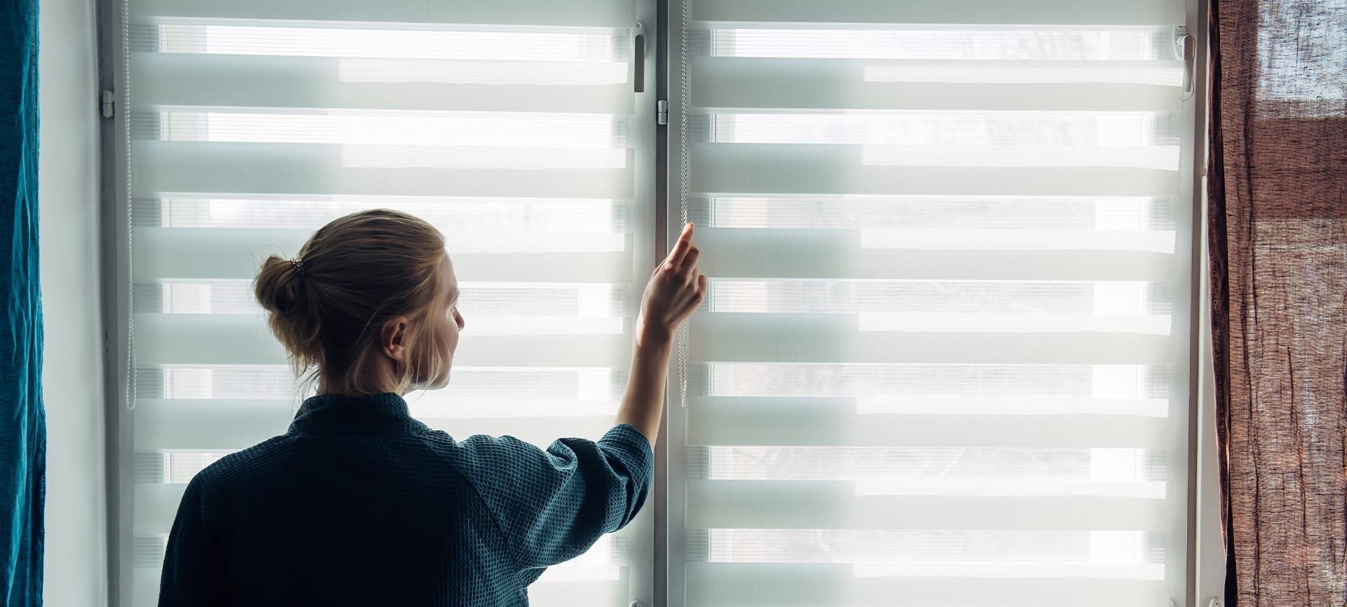 girl adjusting the zebra blind for light control