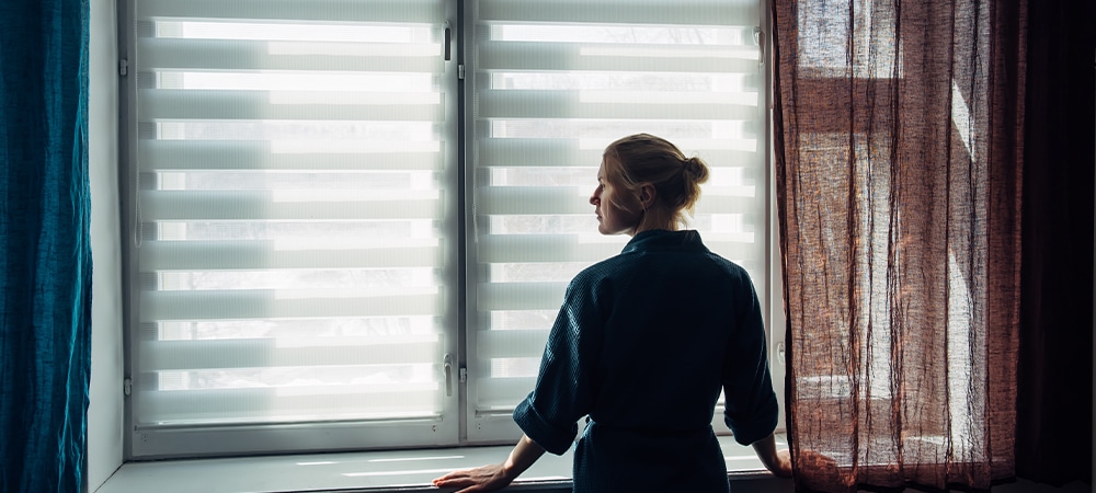 girl looking at light control feature of zebra blind