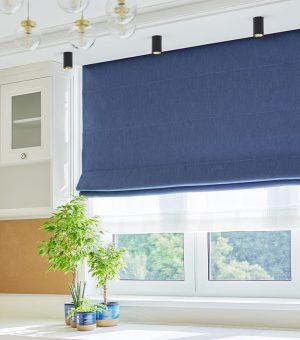 White furniture, table, blue roman blind on the window