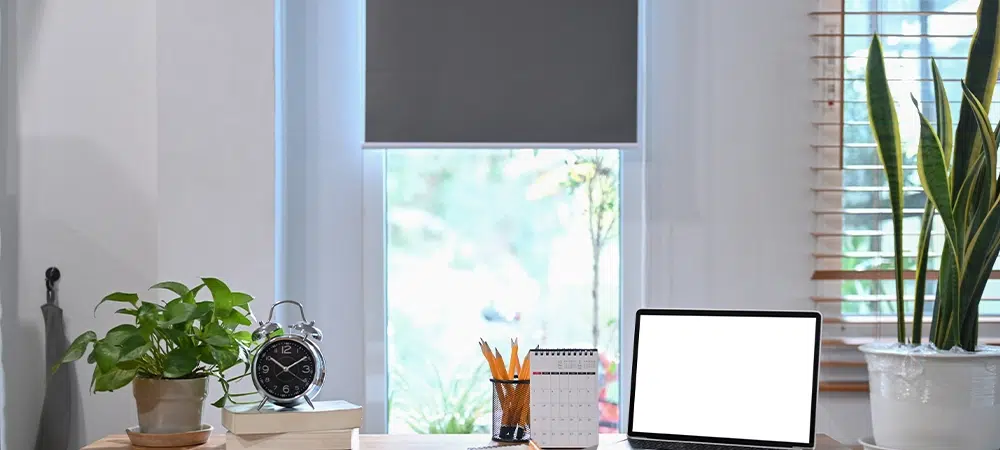 Laptop, Alarm Clock, and Greenery on a Wooden Desk