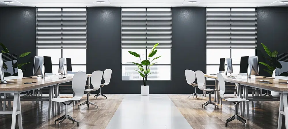 Contemporary bright wooden and concrete coworking office interior with panoramic window and city view, furniture and decorative plants, blinds.