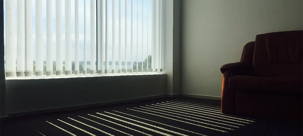 Sunlight Streaming Through Blinds onto a Couch