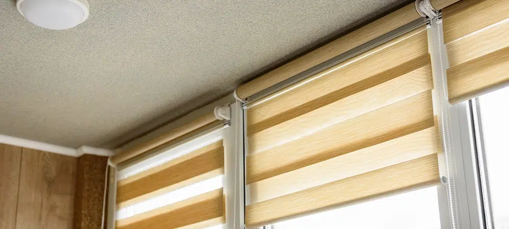 Window roller, duo system day and night in home interior. Beige blinds.
