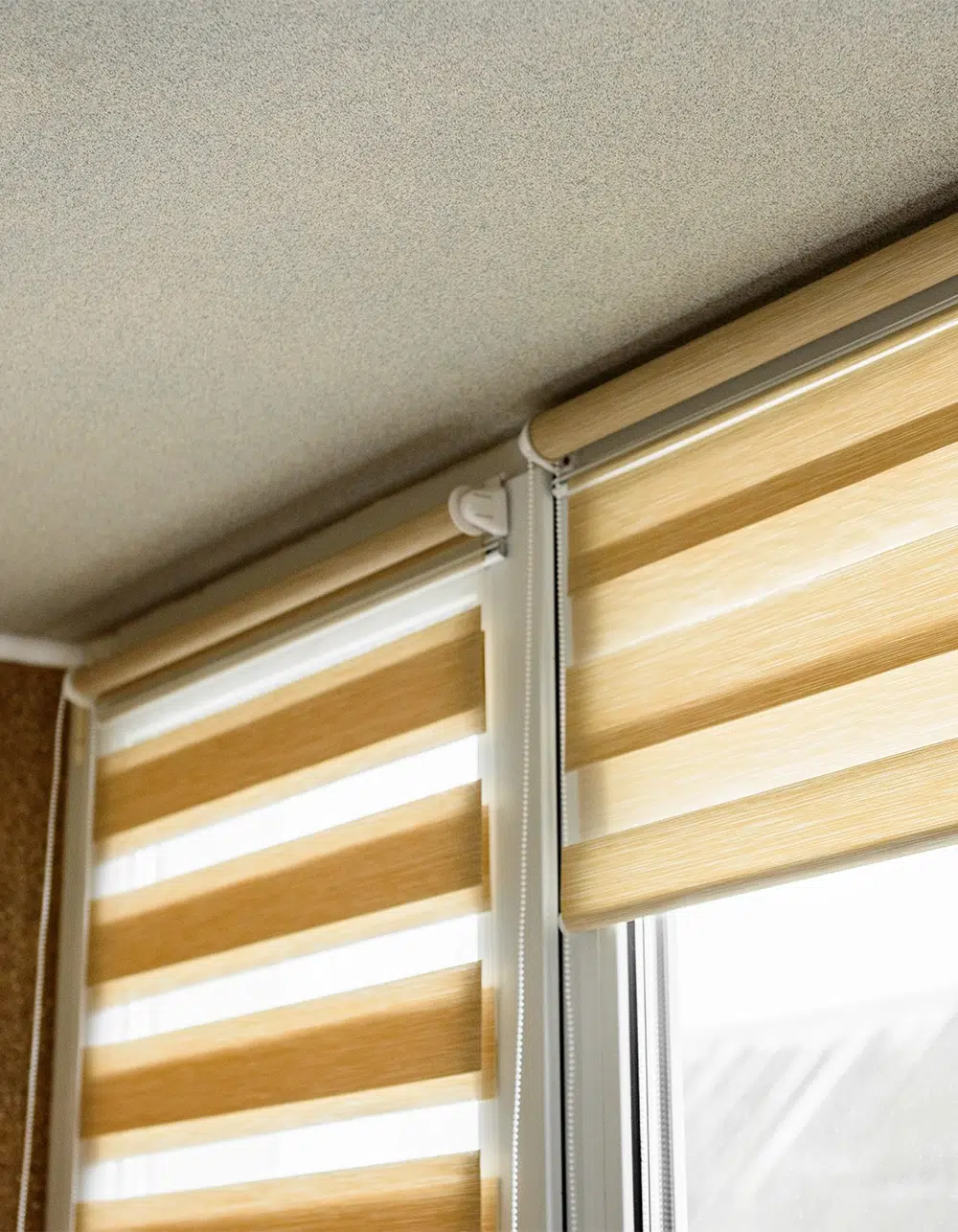 Window roller, duo system day and night in home interior. Beige blinds.