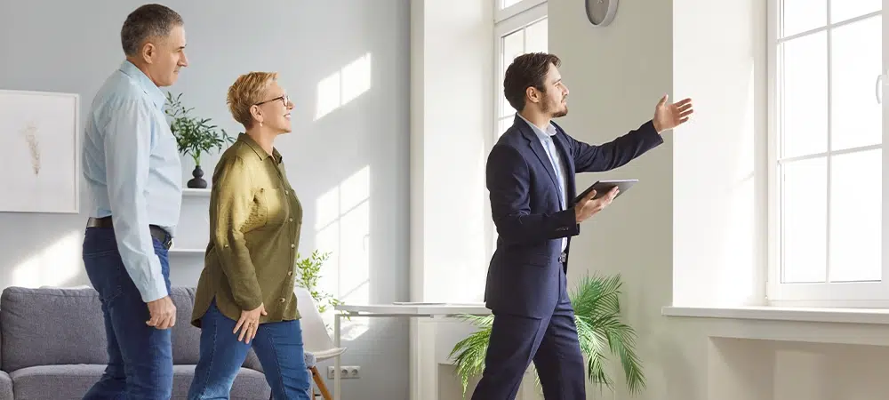 Realtor, real estate agent, broker represents senior sellers or buyer new property flat, clients during meeting looking at room, showing apartment, planning work, having discussion with architect