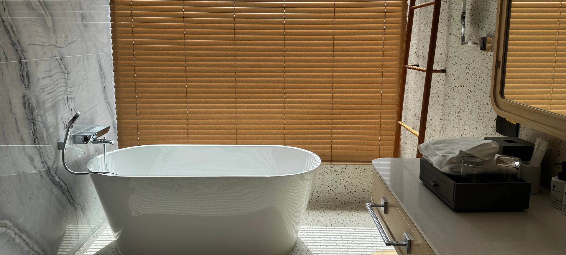 "Spa-like tranquility with warm wood blinds, ample natural light, and a clean, contemporary aesthetic. Includes a wooden towel ladder."